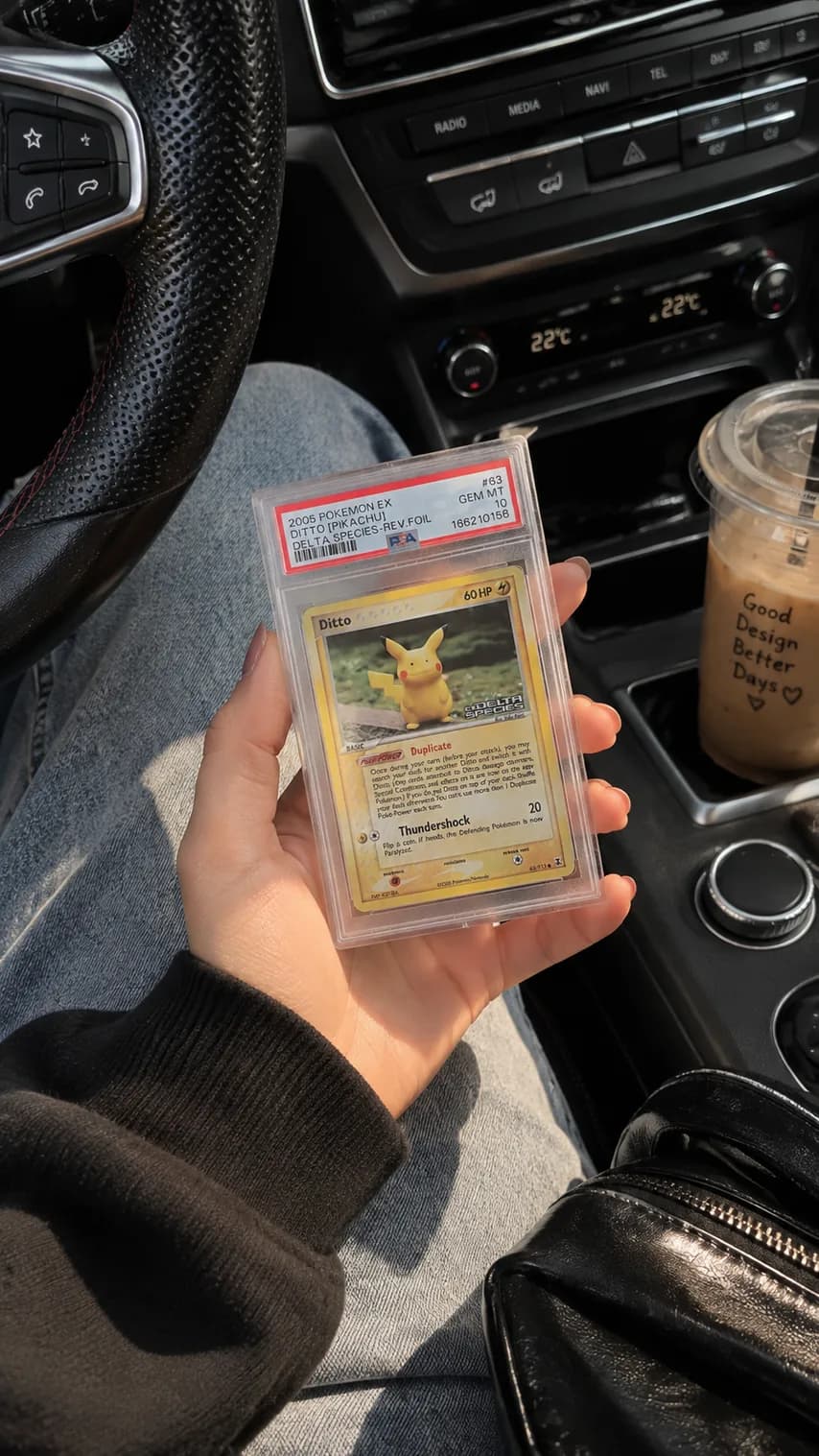A collector holding a graded Pokemon card in its slab